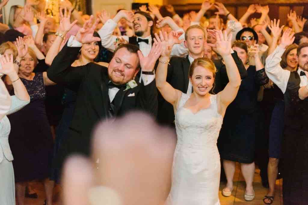 Modern Weddings | Bride and groom on packed dance floor