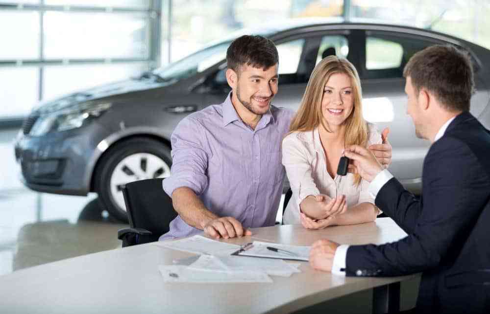Happy couple buying car